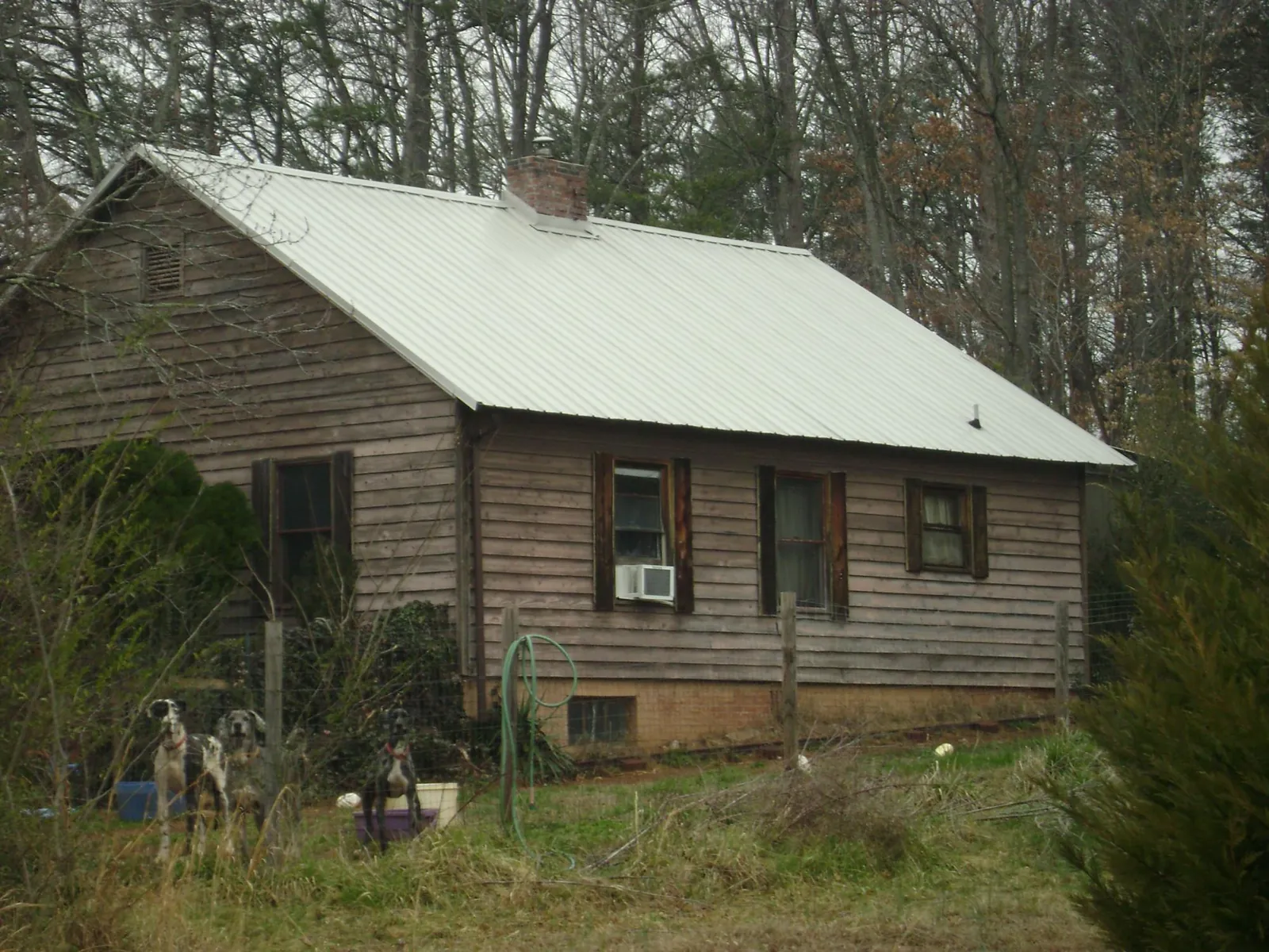 White metal roof on an old wood sided farmhouse, from a Metal Roof Installation job in Port Jervis